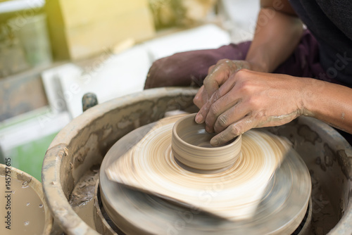 This man is molding a glass of pottery