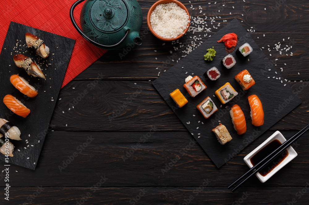 Sushi and rolls background, frame on black, top view. Sushi and rolls background, frame on black, top view.