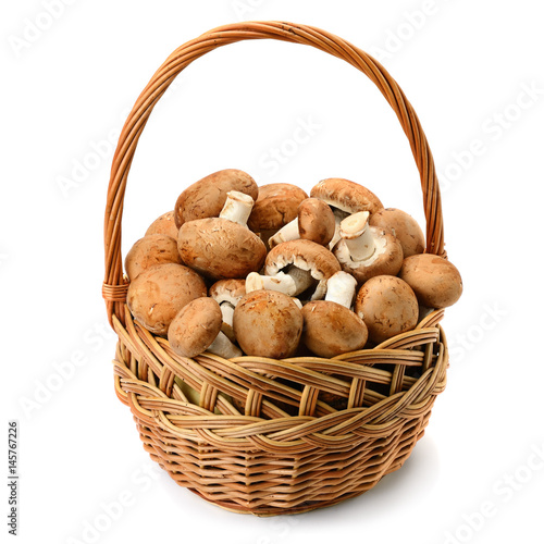 Champignons in wicker basket isolated on white background.