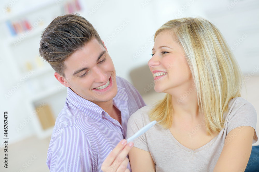 Happy couple with a pregnancy test