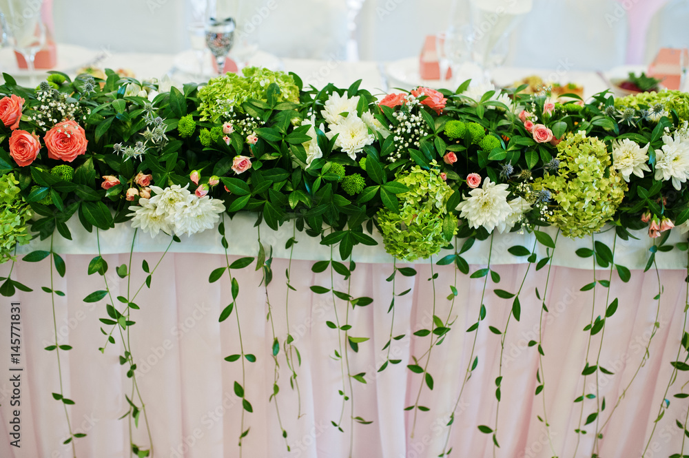 Decor with flowers on wedding table of newlyweds.