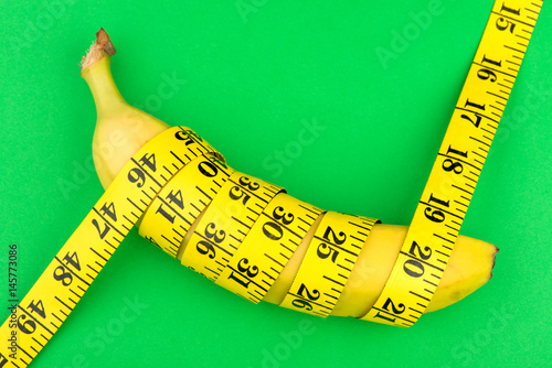 a banana and a centimeter on a green background