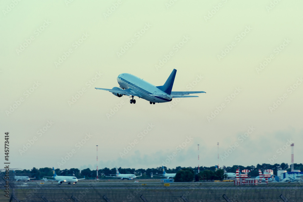 plane takes off from the airport at sunset plane takes off from the airport at sunset