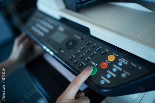 Hand on businesswoman using copy machine