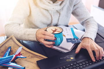 Man holding credit card and buys plane tickets on Internet