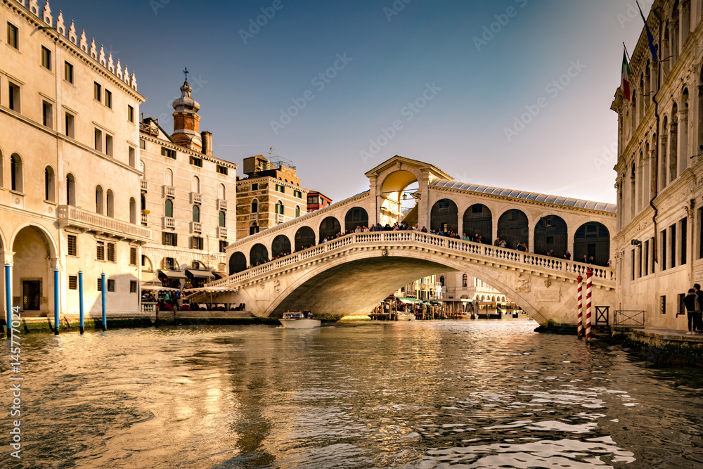 View of the Rialto Bridge in Venice at sunset. View of the Rialto Bridge in Venice at sunset.