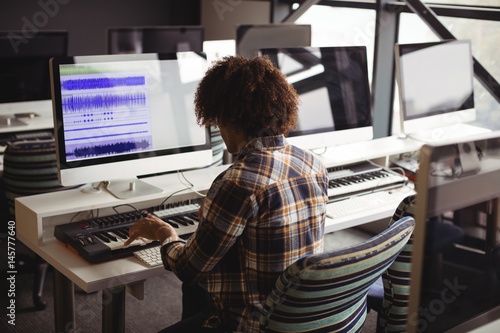 Male audio engineer working on digital editing screen photo