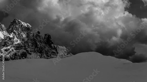 Sweeping, black-and-white timelapse across snowcapped Italian mountains. photo