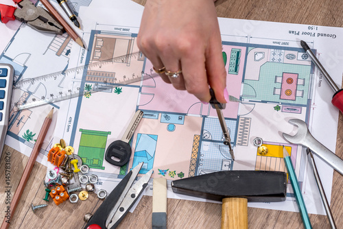 architect working on the design of the building with working tools.