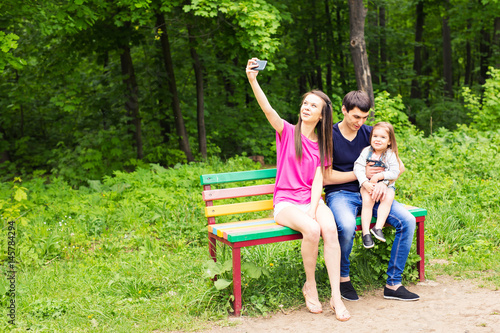 Young family with child girl making selfie outdoors © satura_