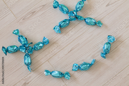 Wallpaper Mural Smiling face made from blue bright candies on light wood background.  Torontodigital.ca