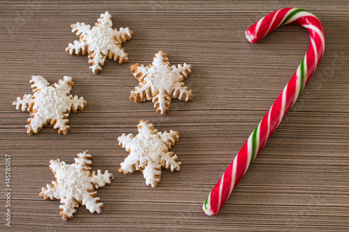 Wallpaper Mural Gingerbread snowflake and lollipop on dark wood background. Aerial view.  Torontodigital.ca
