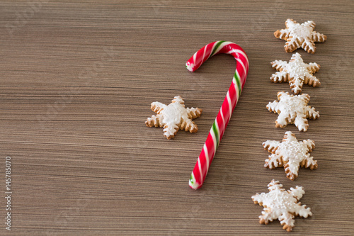 Wallpaper Mural Gingerbread snowflake and lollipop on dark wood background. Aerial view. Copy space. Torontodigital.ca