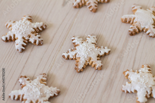 Gingerbread snowflake on wood background. 