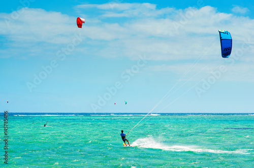 Professional kiter makes the difficult trick on a beautiful background, Mauritius