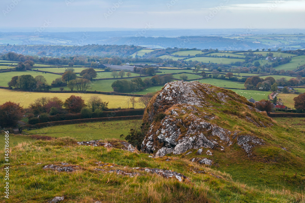 Atmospheric view of the Dartmoor National Park from the peak of Brentor. Autumn, light haze. Evening. Devon. England Atmospheric view of the Dartmoor National Park from the peak of Brentor. Autumn, light haze. Evening. Devon. England