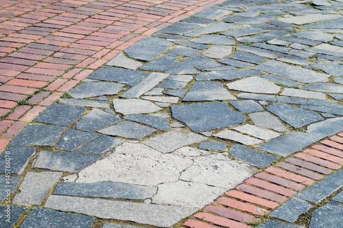 Road surface made of bricks and granite tiles