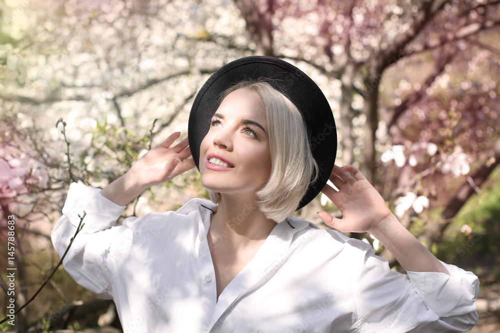 Young blonde girl in hat on blurred background Young blonde girl in hat on blurred background