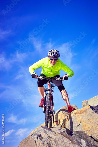 A cyclist who travels in the mountains in summer on a sunny day