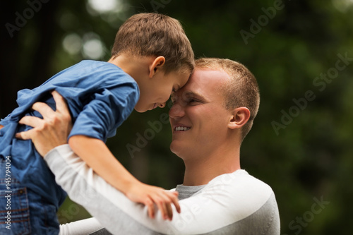 Dad and son playing in park