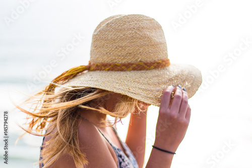 Young, blonde female, girl in a straw hat on the sun. California. Spring. Pacific ocean. California	