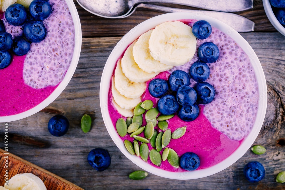 Healthy breakfast: purple smoothie bowl with chia pudding, banana, fresh  blueberries and pumpkin seeds Stock Photo | Adobe Stock