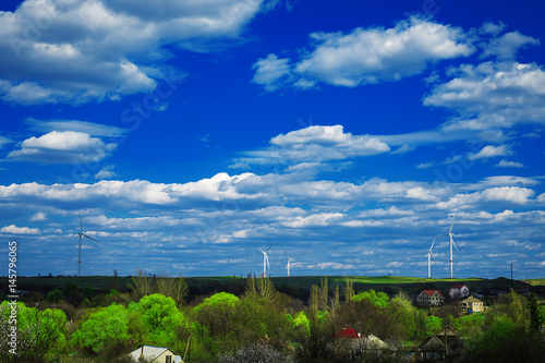 wind turbnes on a summer field photo