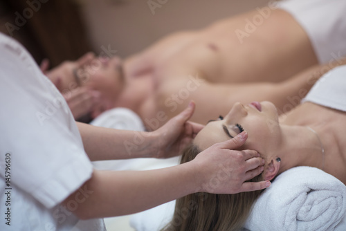 couple enjoying head massage at the spa