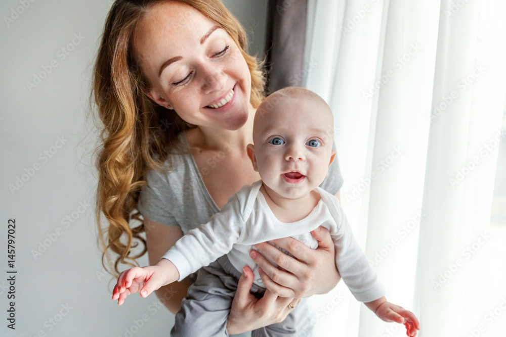 Young mother holding her newborn child Young mother holding her newborn child