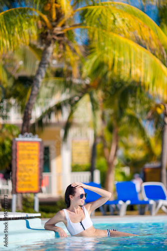 Beautiful young woman relaxing in swimming pool © travnikovstudio