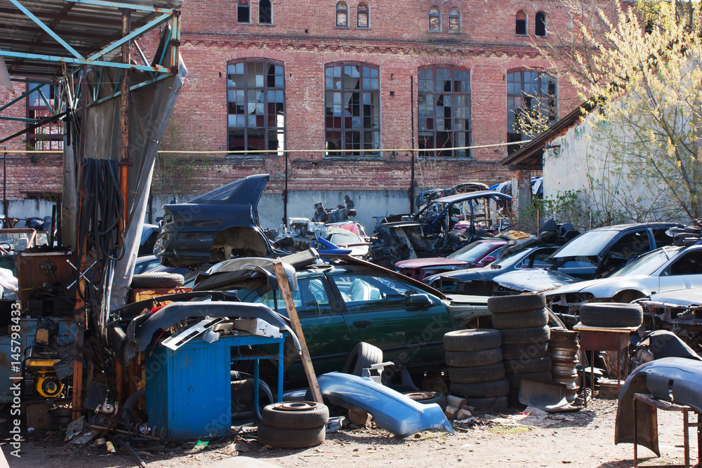 Naklejka premium abandoned dump of broken cars, spare parts, wheels