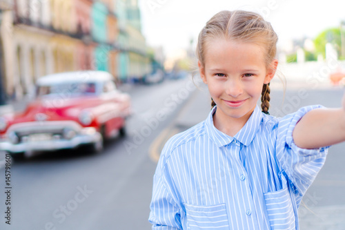 Photography Little girl taking selfie in popular area in Old Havana, Cuba