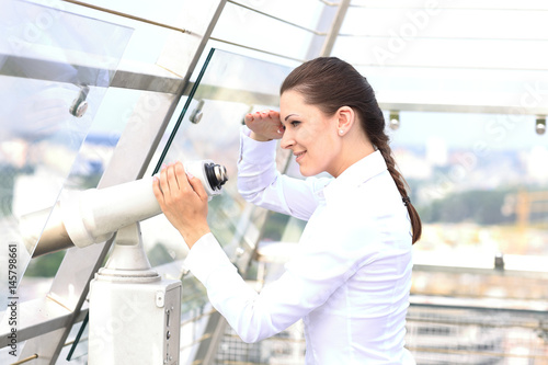 woman looking through binoculars