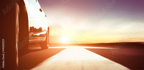 fast car on the road with arrow at sunset