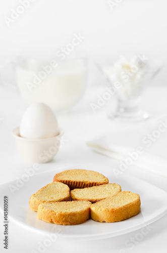 Toasts of white bread for Breakfast, milk with cottage cheese and egg. High key, selective focus.