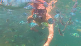 Girl bathe in the sea with fish. Scuba Diving in Masks