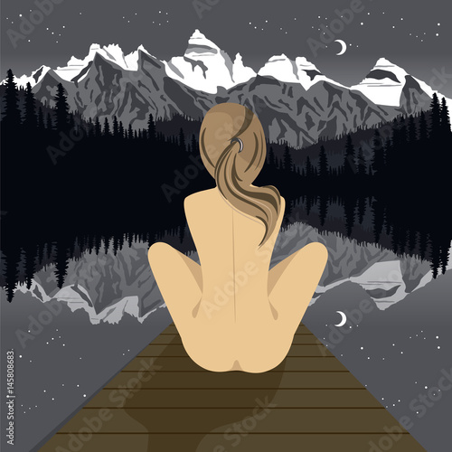 Beautiful young nude woman sitting on pier looking at mountain lake at night