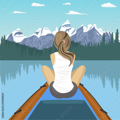 Woman traveler floating on boat on mountain lake