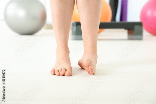 Feet of woman doing exercises in clinic
