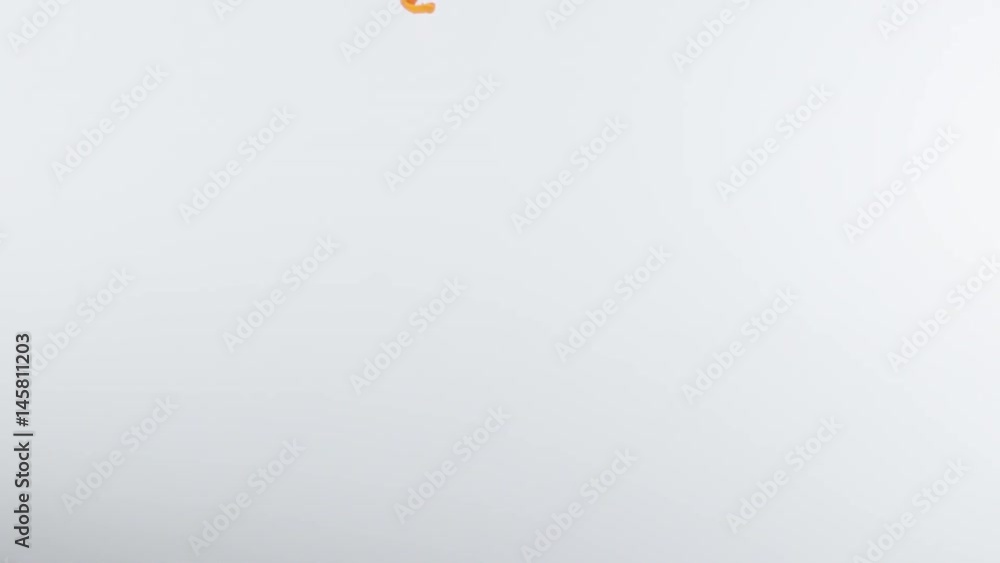 Yellow liquid descends from top of frame, pluming out into a cloud over white BG Yellow liquid descends from top of frame, pluming out into a cloud over white BG