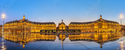 Iconic panorama of Place de la Bourse with tram and water mirror fountain in Bordeaux, France