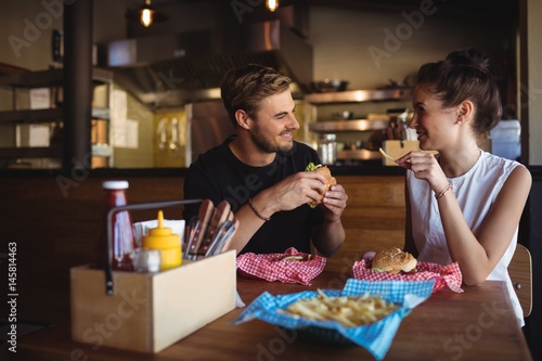 Happy couple interacting while fast food