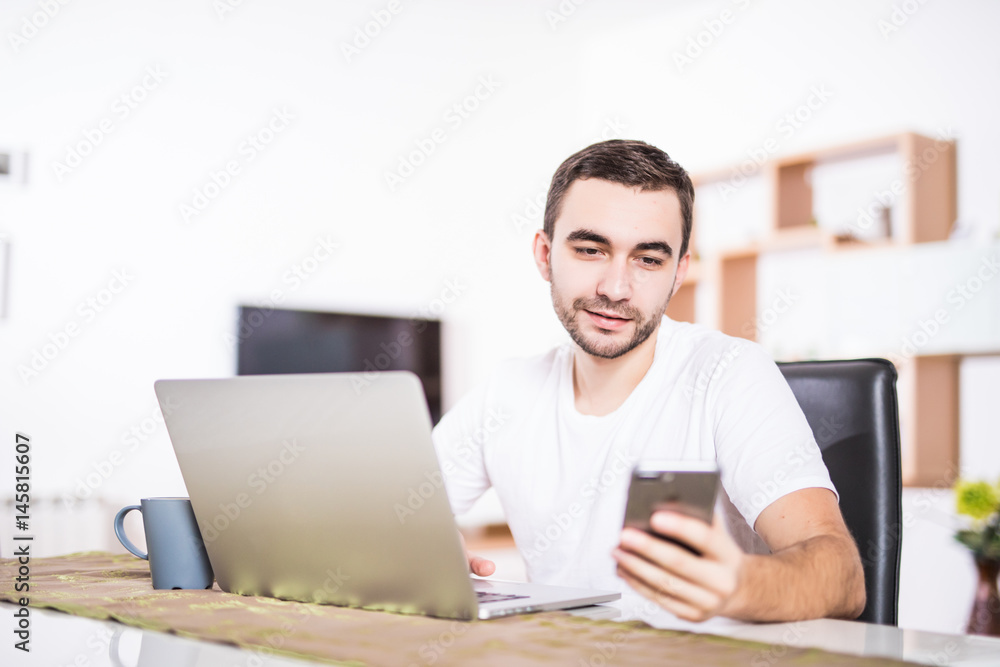Thoughtful man with laptop and cup of coffee in the morning at kitchen Thoughtful man with laptop and cup of coffee in the morning at kitchen