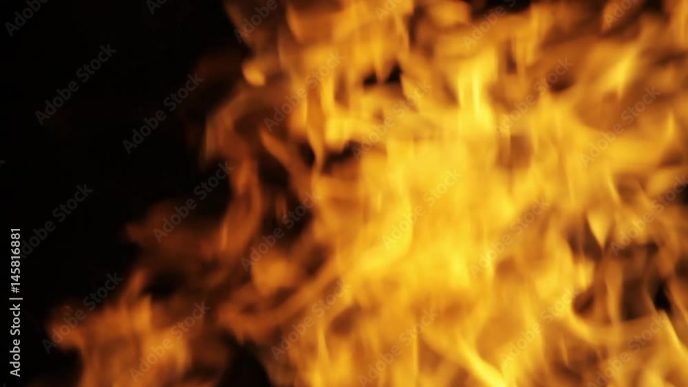 A macro closeup of the flames of a campfire burning in the night A macro closeup of the flames of a campfire burning in the night