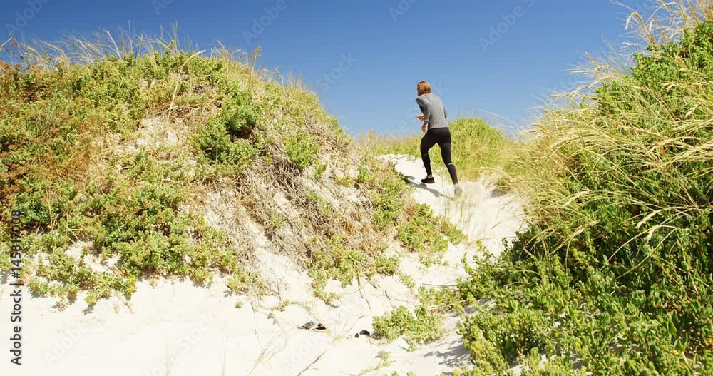 Triathlete man jogging on a trail