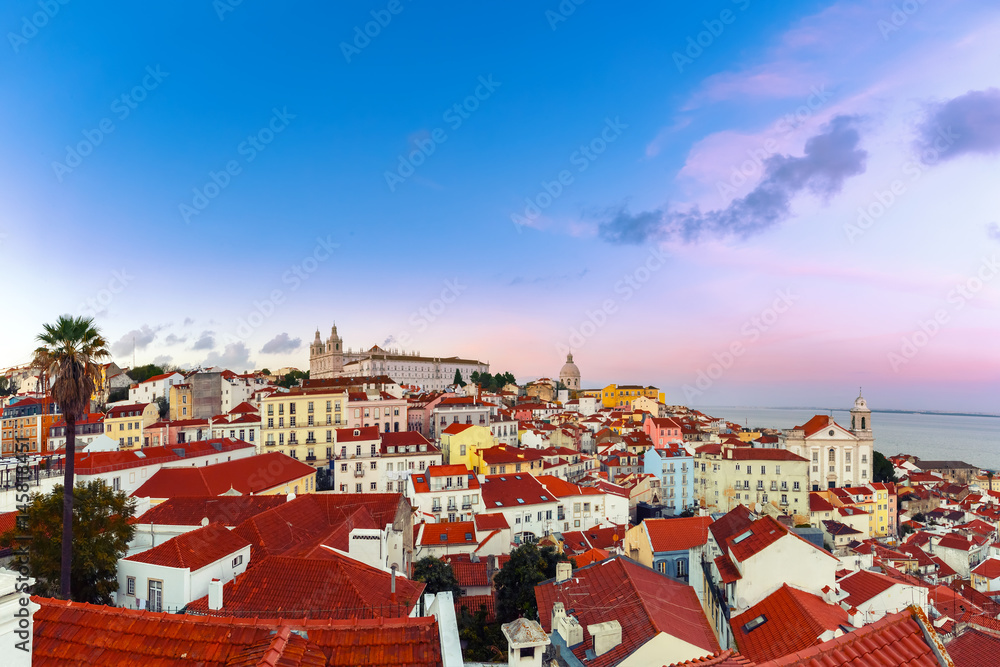Panoramic view of Alfama, the oldest district of the Old Town, with Monastery of Sao Vicente de Fora, Church of Saint Stephen and National Pantheon dat sunset, Lisbon, Portugal