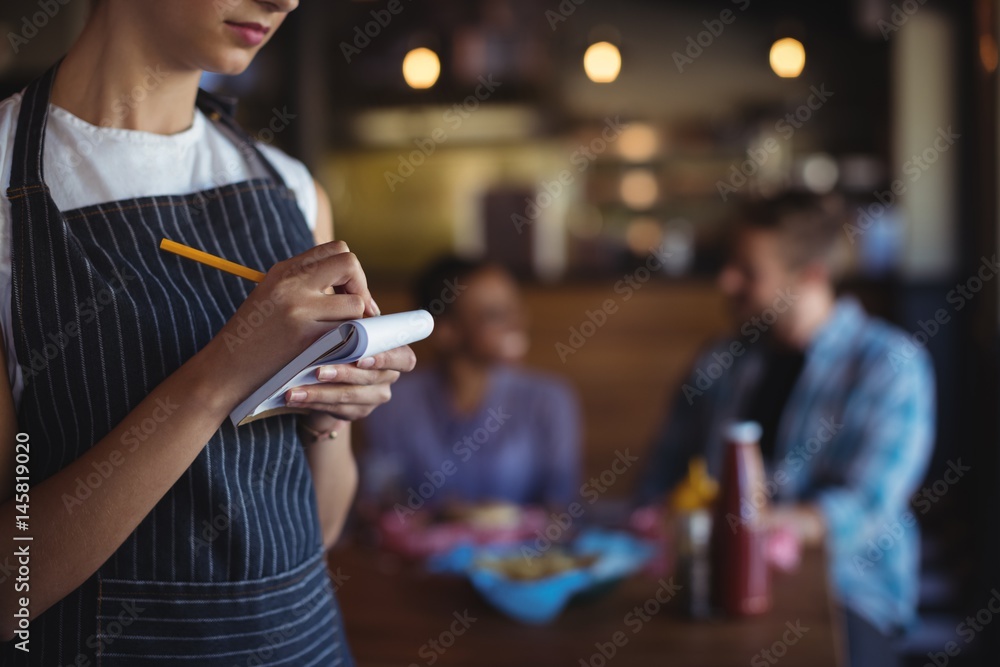 © wavebreak3 - Waitress taking order at restaurant © wavebreak3 - Waitress taking order at restaurant