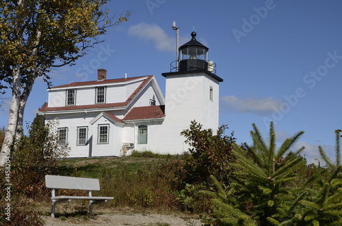 Fort Point Lighthouse on the Penobscot River near Stockton Springs, Maine. In the foreground there are a bench.