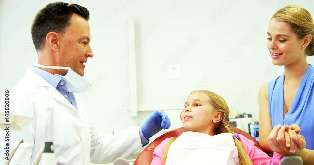 Dentist interacting with young patient Dentist interacting with young patient