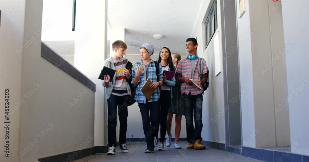 Group of classmate walking in corridor Group of classmate walking in corridor